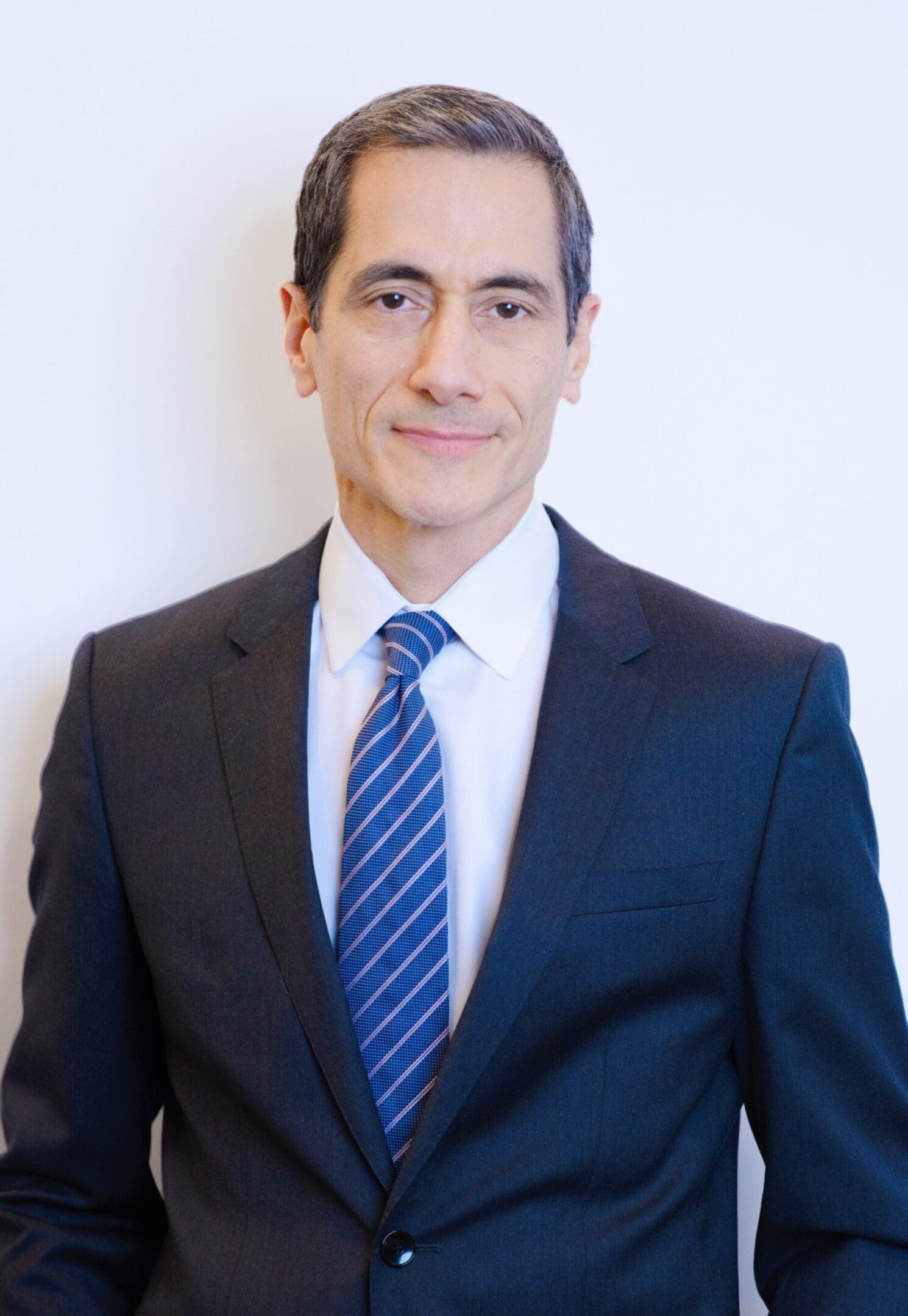 Man in suit with blue striped tie.