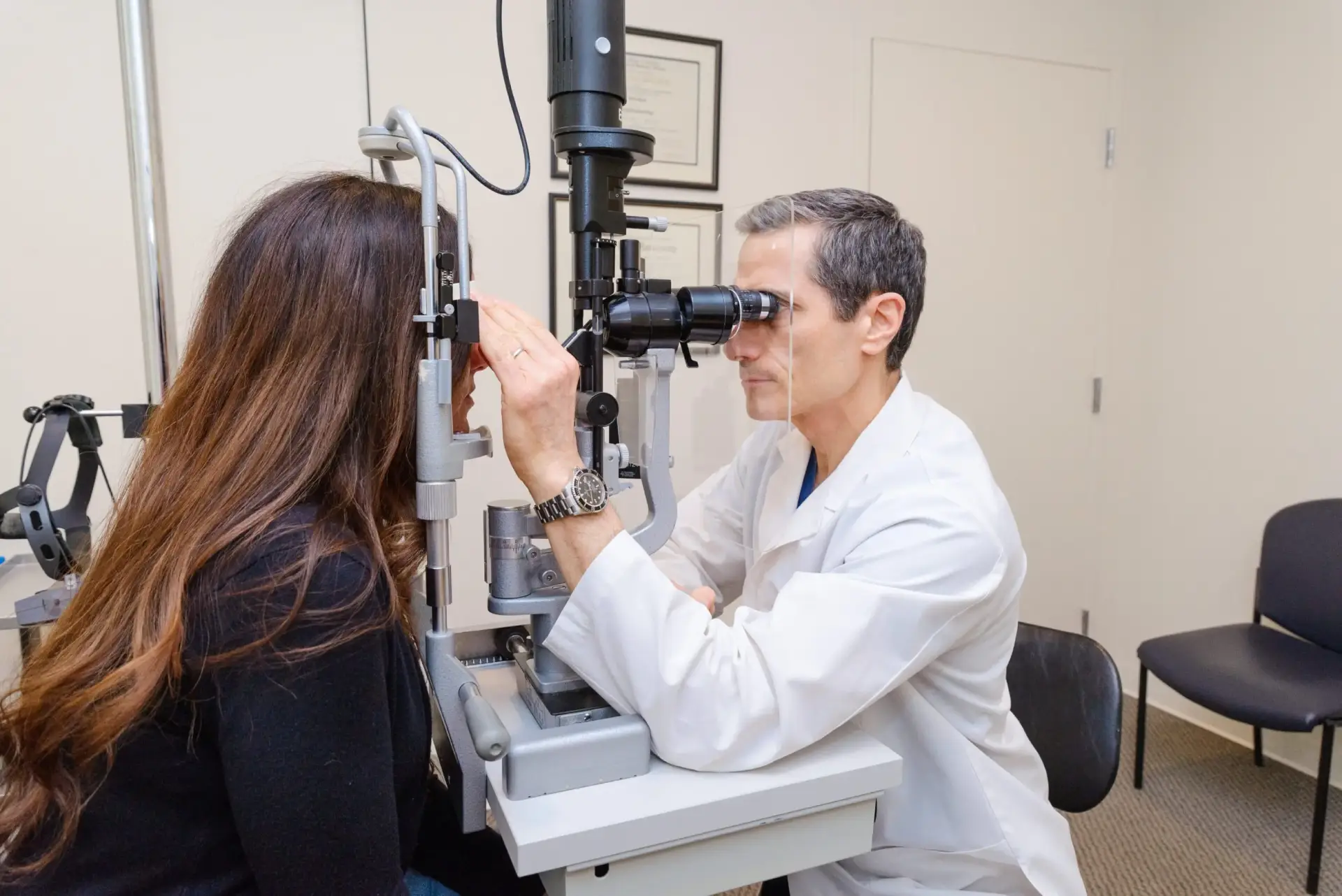 Eye examination with slit lamp in clinic.